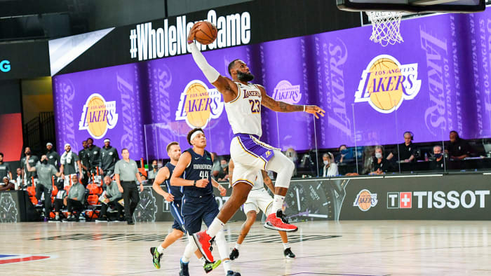 LeBron James of the Lakers dunks the ball
